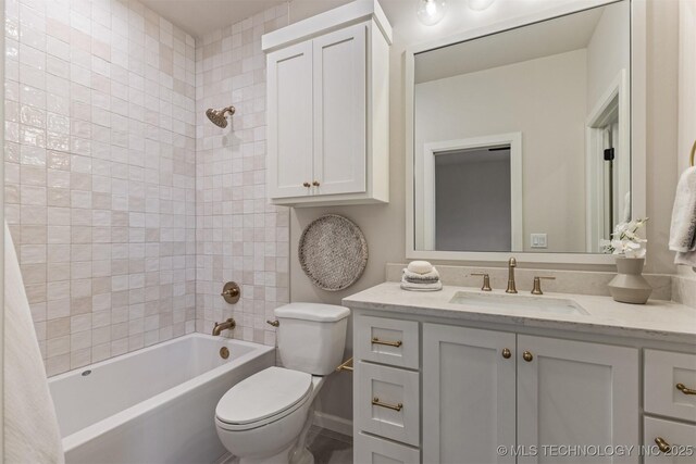 full bathroom with toilet, tiled shower / bath combo, and vanity