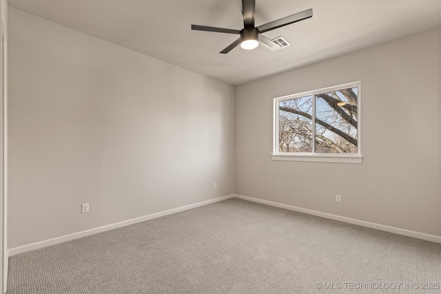 spare room with ceiling fan and carpet