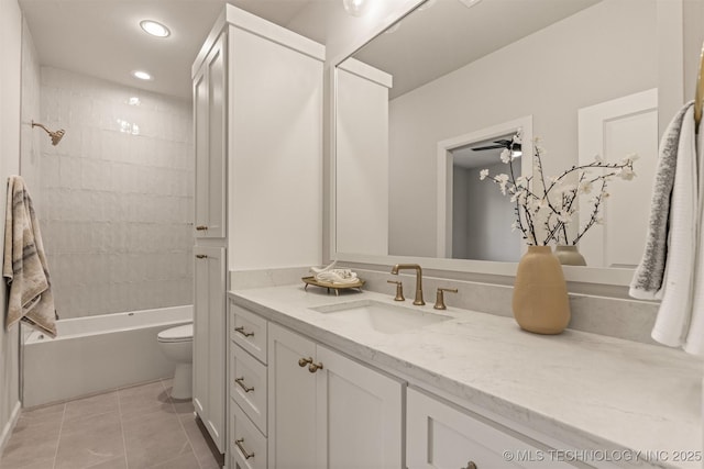 full bathroom with toilet, tiled shower / bath combo, ceiling fan, tile patterned flooring, and vanity