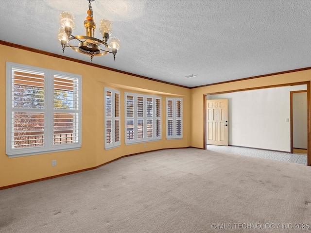 empty room featuring light colored carpet, a textured ceiling, ornamental molding, and a notable chandelier