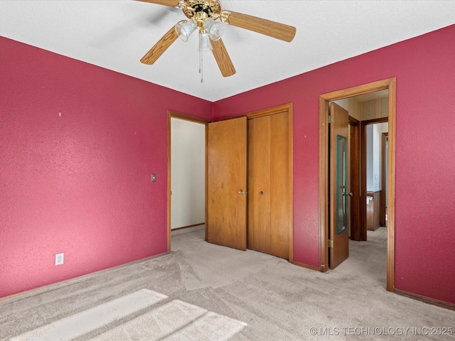 unfurnished bedroom with ceiling fan, a closet, and light colored carpet