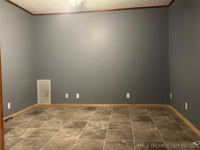 spare room featuring ornamental molding and a textured ceiling