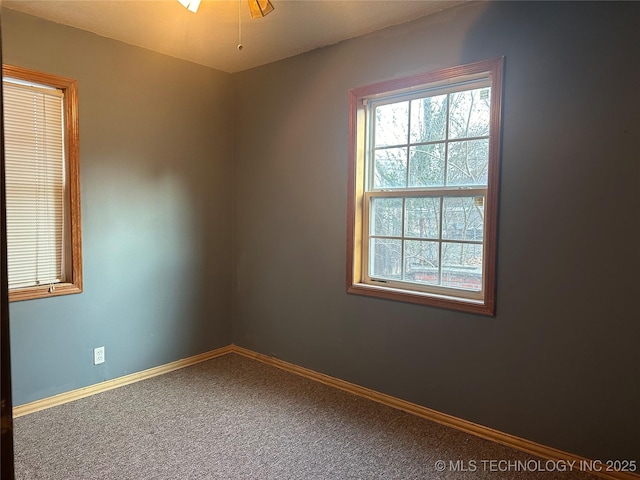 carpeted empty room featuring ceiling fan