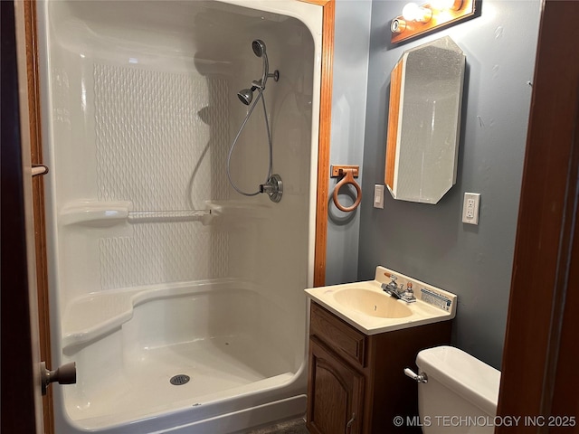 bathroom with vanity, toilet, and walk in shower