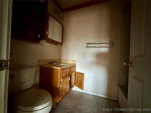 bathroom featuring a tub to relax in, toilet, vanity, and tile patterned flooring