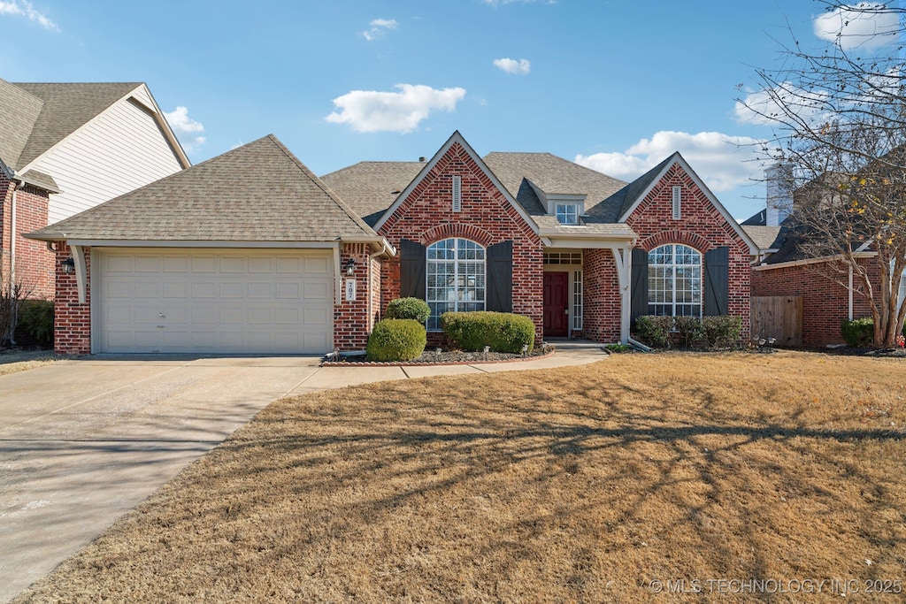 view of front property with a front lawn and a garage