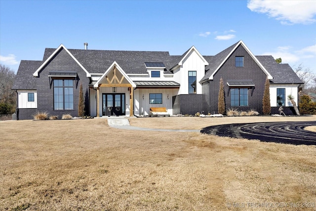 modern inspired farmhouse with a front lawn