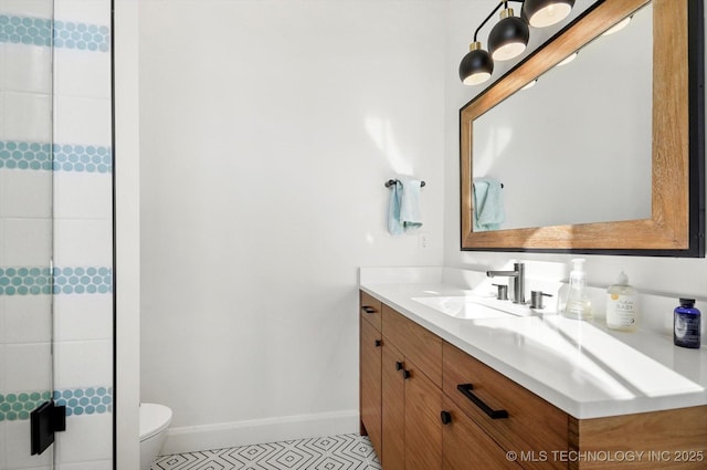 bathroom with toilet, vanity, tile patterned flooring, and walk in shower