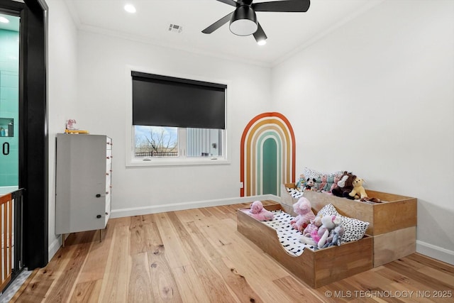 interior space with ceiling fan, crown molding, and hardwood / wood-style floors