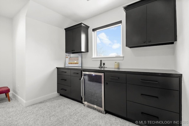 kitchen featuring light colored carpet and beverage cooler