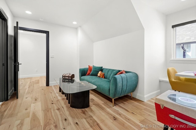 living area with lofted ceiling and light wood-type flooring