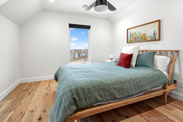 bedroom featuring ceiling fan, vaulted ceiling, and hardwood / wood-style flooring