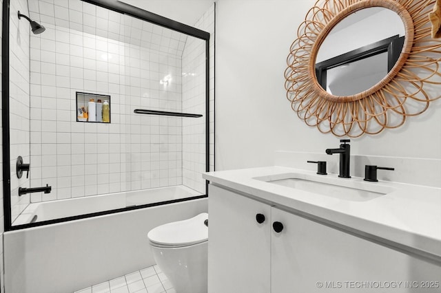 full bathroom featuring toilet, tile patterned flooring, enclosed tub / shower combo, and vanity