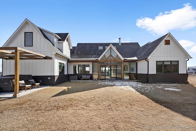 back of property with a pergola, a patio area, and a hot tub