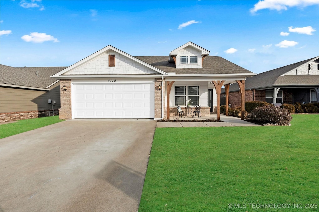 view of front of home with a garage and a front lawn