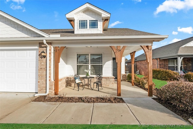 exterior space with a garage and covered porch