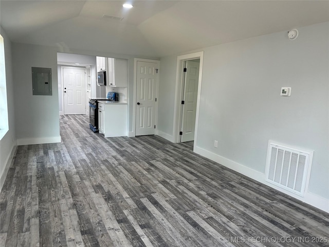 unfurnished living room with lofted ceiling, dark wood-type flooring, and electric panel