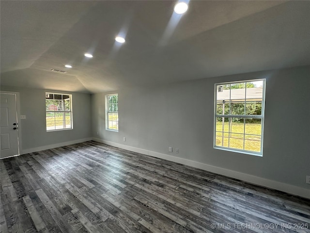 spare room with dark hardwood / wood-style floors and vaulted ceiling