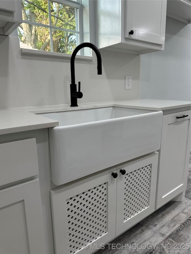 interior details featuring sink and hardwood / wood-style flooring