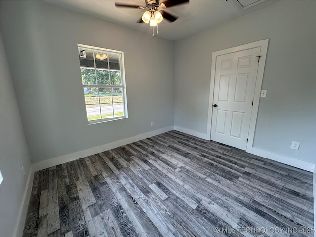 unfurnished room featuring ceiling fan and dark hardwood / wood-style flooring