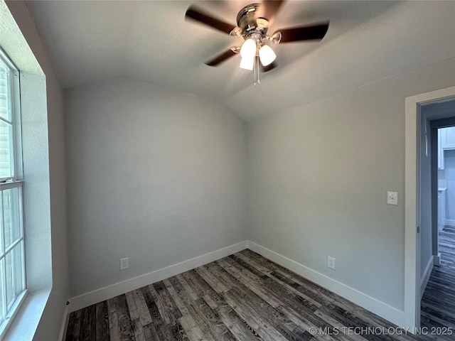 empty room with ceiling fan, dark wood-type flooring, and lofted ceiling