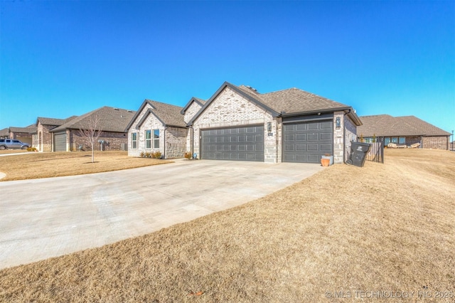 view of front of house featuring a garage and a front yard