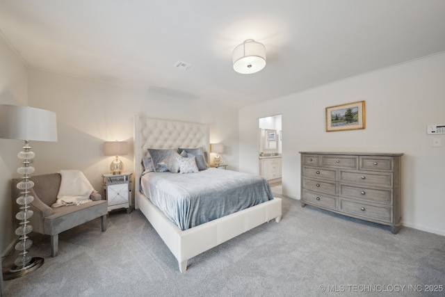 carpeted bedroom featuring connected bathroom