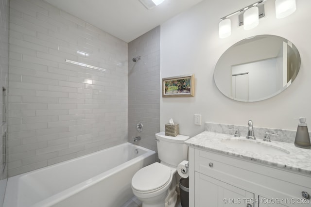 full bathroom with toilet, vanity, and tiled shower / bath