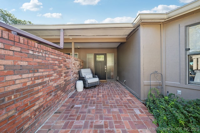 property entrance featuring a patio