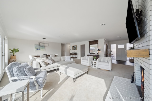 living room with light carpet and a brick fireplace