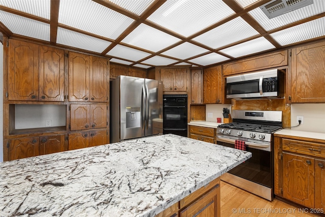 kitchen featuring light wood-type flooring and appliances with stainless steel finishes