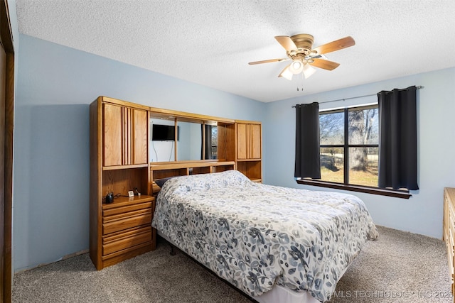 carpeted bedroom with a textured ceiling and ceiling fan