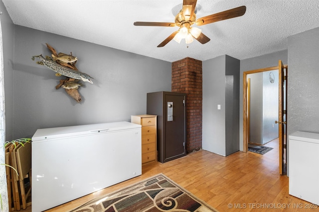 washroom featuring ceiling fan, washer / clothes dryer, a textured ceiling, and light wood-type flooring