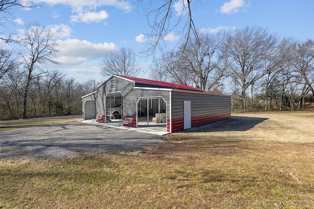 view of outbuilding with a garage and a yard