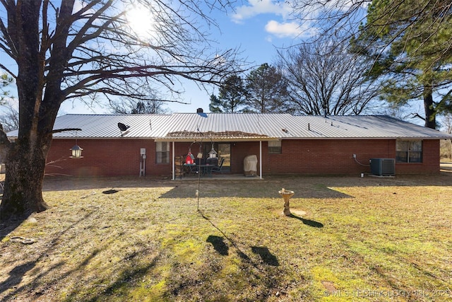 back of house with cooling unit, a yard, and a patio