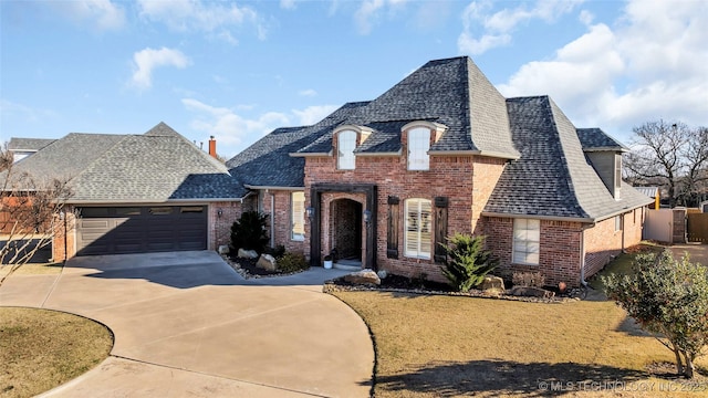 french provincial home featuring a garage