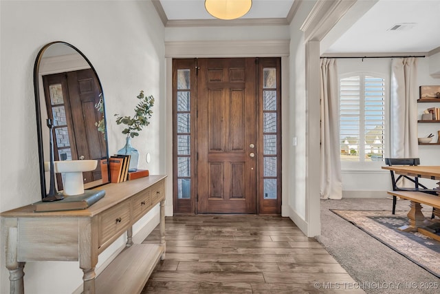 entryway with dark wood-type flooring and ornamental molding