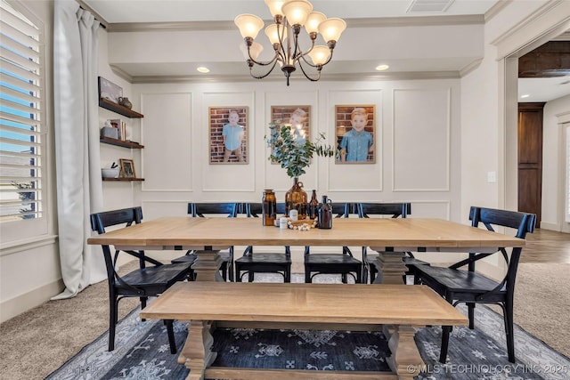 carpeted dining area with ornamental molding and a notable chandelier