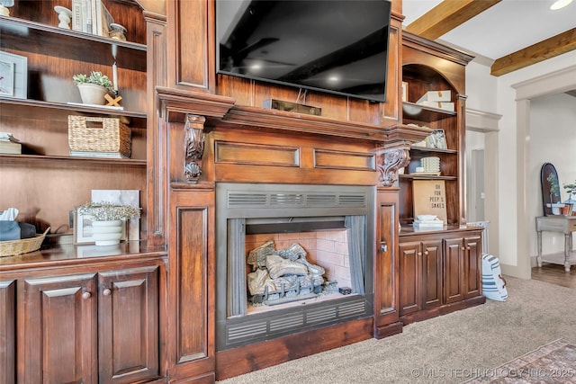 room details with built in features, beam ceiling, and carpet flooring