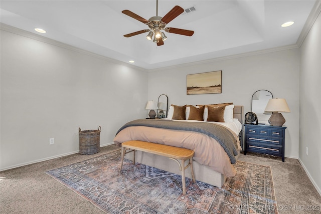 bedroom featuring ceiling fan, carpet flooring, ornamental molding, and a tray ceiling