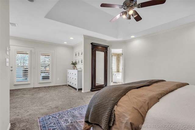 bedroom with ceiling fan, crown molding, a tray ceiling, carpet flooring, and connected bathroom