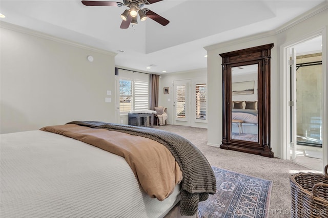 bedroom featuring ceiling fan, carpet, ornamental molding, and a tray ceiling