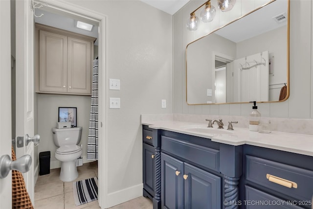 bathroom with toilet, tile patterned flooring, and vanity