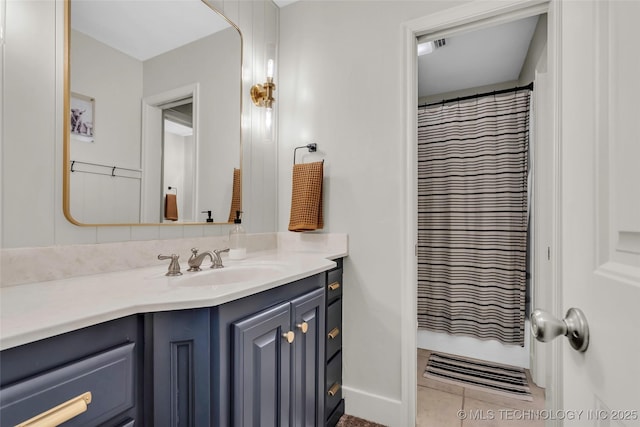 bathroom featuring tile patterned floors, vanity, and walk in shower