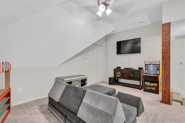 living room featuring ceiling fan, lofted ceiling, and light carpet