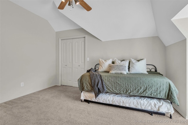 carpeted bedroom featuring ceiling fan, a closet, and vaulted ceiling