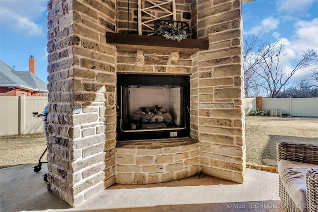 details with an outdoor stone fireplace