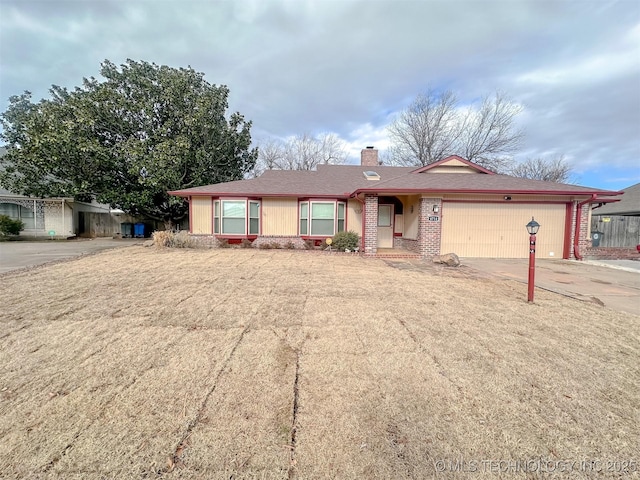 single story home featuring a front yard and a garage