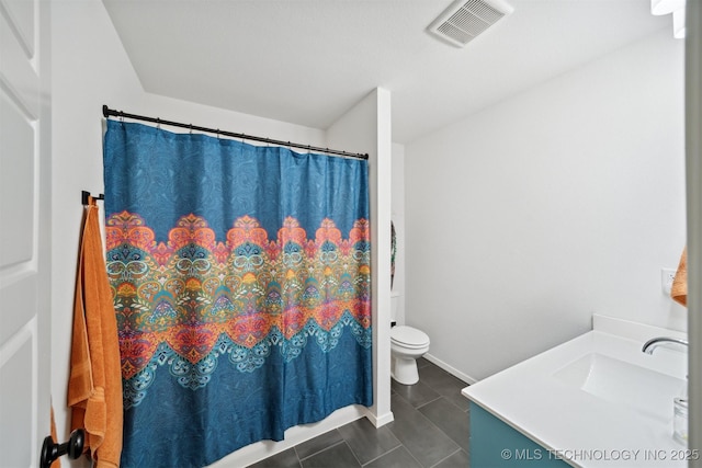 bathroom featuring vanity, toilet, and tile patterned floors