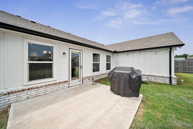 back of house with a patio and a yard